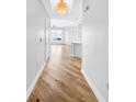 Bright hallway featuring beautiful hardwood floors that lead to an open living space with expansive windows at 1209 E Cumberland Ave # 2006, Tampa, FL 33602
