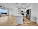 Modern white kitchen with stainless steel appliances, quartz countertops, and hardwood floors at 1209 E Cumberland Ave # 2006, Tampa, FL 33602