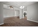 Spacious living room with hardwood floors, neutral paint, and decorative archways to other rooms at 12256 Creek Preserve Dr, Riverview, FL 33579
