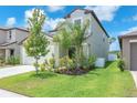 View of home highlighting the well-maintained lawn and lush landscaping at 12715 Maple Bonsai Dr, Riverview, FL 33579