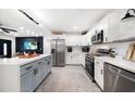 Modern kitchen with stainless steel appliances, a large center island, and white and gray cabinetry at 14 S Meteor Ave, Clearwater, FL 33765
