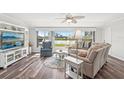 Bright living room with lake views, hardwood floors, and comfortable seating arrangement at 1405 W Del Webb Blvd, Sun City Center, FL 33573