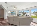 Inviting living room with hardwood floors, neutral decor, and large windows overlooking the lake at 1405 W Del Webb Blvd, Sun City Center, FL 33573