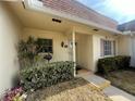 Close-up of a welcoming home entrance with a covered porch and manicured shrubbery at 1654 S Lake Ave # 2, Clearwater, FL 33756