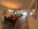 Open-concept living area with dining space, neutral tones, and lots of natural light at 1654 S Lake Ave # 2, Clearwater, FL 33756