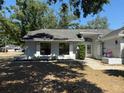 Home exterior with a well-manicured lawn and landscaped garden beds along the entryway at 1710 Tallowtree Cir, Valrico, FL 33594