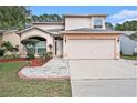 Charming two-story home featuring a two-car garage and manicured landscaping, creating an inviting curb appeal at 1719 Bayhill Dr, Oldsmar, FL 34677