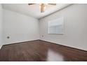 Bedroom with dark wood floors, white walls, a ceiling fan and a window at 2111 W Grace St, Tampa, FL 33607