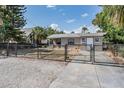 Cozy home with chain-link fence, a well-maintained lawn, and a concrete driveway at 2111 W Grace St, Tampa, FL 33607