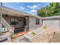 Charming bungalow with a landscaped front yard, a cozy porch, and secure windows at 2111 W Grace St, Tampa, FL 33607