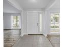 Inviting entryway featuring neutral tile floors, a frosted glass door, and sun-filled windows at 2146 Egret Drive, Clearwater, FL 33764