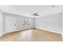 Bright and airy living room featuring wood flooring and a contemporary ceiling fan at 2921 N 18Th St, Tampa, FL 33605