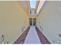Inviting entrance to attached townhomes, walkway adorned with mulch landscaping at 3072 Inlet Breeze Way, Holiday, FL 34691