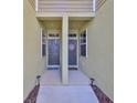Shared walkway between townhomes, front doors with decorative wreaths at 3072 Inlet Breeze Way, Holiday, FL 34691