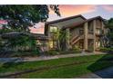 Beautiful two-story home with lovely front yard landscaping and outdoor staircase at 3079 Landmark Blvd # 1608, Palm Harbor, FL 34684