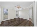 Bright bedroom featuring neutral walls, a ceiling fan, and stylish dark wood flooring at 3123 Laird Dr, New Port Richey, FL 34655