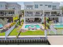 Expansive backyard oasis with a pool, outdoor seating, fire pit, and scenic waterfront views at 344 Capri Blvd, Treasure Island, FL 33706