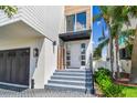 Inviting entrance featuring a modern door, elegant steps, and a well-maintained, landscaped walkway at 344 Capri Blvd, Treasure Island, FL 33706