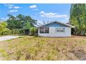 Charming one-story home with a cozy front yard and mature trees at sunset at 3614 Fortner Rd, Plant City, FL 33567