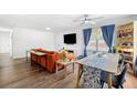 Bright living room area with modern decor, hardwood floors, and a large window offering ample natural light at 3801 Carroway St, Tampa, FL 33619