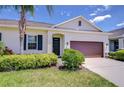 Charming single-story home featuring a well-manicured lawn, neat shrubbery and a decorative front door at 5732 Stockport St, Riverview, FL 33578