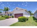 Charming single-story home featuring a well-manicured lawn, neat shrubbery and an attached two car garage at 5732 Stockport St, Riverview, FL 33578
