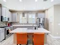 Well-lit kitchen with stainless steel appliances, gray cabinetry, a tile backsplash, and pendant lights at 5807 Circa Fishhawk Blvd, Lithia, FL 33547