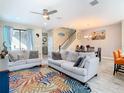 Inviting living room featuring a colorful area rug, comfortable sofas, and an adjacent dining area at 5807 Circa Fishhawk Blvd, Lithia, FL 33547