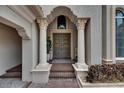 Charming entryway with ornate columns, decorative pineapples on doors, and a welcoming ambiance at 624 Balibay Rd, Apollo Beach, FL 33572
