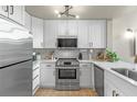 Modern kitchen featuring stainless steel appliances, white cabinetry, and elegant marble countertops at 700 S Harbour Island Blvd # 105, Tampa, FL 33602