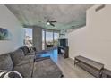 Relaxing living area with large windows, a ceiling fan, and a view to the outdoor balcony at 777 N Ashley Dr # 1011, Tampa, FL 33602