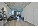 Bright living room featuring a comfortable gray sectional, concrete ceilings, and a view to the outdoor balcony at 777 N Ashley Dr # 1011, Tampa, FL 33602