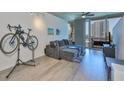 Modern living room with stylish gray sectional, concrete ceilings, and city views from the large windows at 777 N Ashley Dr # 1011, Tampa, FL 33602