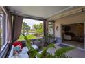 Relaxing screened lanai boasting comfortable seating and a picturesque water view, blending indoor and outdoor living seamlessly at 815 Silverthorn Ln # 0, Sun City Center, FL 33573