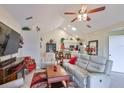 Bright living room boasts a ceiling fan, vaulted ceilings, and access to kitchen at 815 Silverthorn Ln # 0, Sun City Center, FL 33573