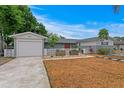 Beautiful home featuring a well-kept lawn, decorative front fence, and a driveway leading to the attached garage at 8407 Granite Pl, Tampa, FL 33615
