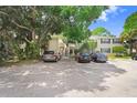 Two-story condo building with parking area and cars parked nearby at 134 Sycamore Ln # F, Oldsmar, FL 34677
