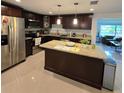 Modern kitchen with stainless steel appliances, granite counters and cherry wood cabinets at 1412 Sunset Ln, Lutz, FL 33549