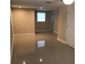 Bright, open-concept living room with neutral walls and glossy tile floors at 1412 Sunset Ln, Lutz, FL 33549