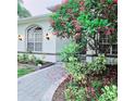 Landscaped front entrance with beautiful bushes and trees surrounding the walkway at 1415 Beach Club, Apollo Beach, FL 33572