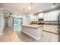 Spacious kitchen featuring an island, granite countertops, stainless steel appliances, and pendant lighting at 16226 Bayberry View Dr, Lithia, FL 33547