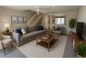 Bright living room with neutral tones, cozy seating, and natural light at 16530 Brigadoon Dr, Tampa, FL 33618