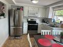 Modern kitchen features stainless steel appliances and a cozy dining area at 192 Tulane Rd, Venice, FL 34293