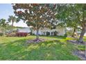 Single story home with a lush green lawn and mature trees at 2115 N Halcyon Dr # 510, Sun City Center, FL 33573