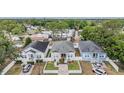 Aerial view of the home with manicured lawns, white picket fence, and adjacent homes at 260 Sw Lincoln N Cir, St Petersburg, FL 33703
