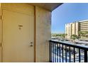 Balcony view showcasing the building exterior with covered parking and clear blue skies at 2614 Cove Cay Dr # 409, Clearwater, FL 33760