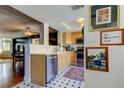 Well-lit kitchen with light wood cabinetry, stainless steel appliances and a view into the dining room at 2614 Cove Cay Dr # 409, Clearwater, FL 33760