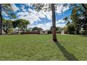 Landscaped front yard and large shade tree, creating an inviting curb appeal at 2679 Haines Bayshore Rd, Clearwater, FL 33760