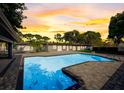 Beautiful pool area with a large pool and a tranquil setting at sunset at 2679 Haines Bayshore Rd, Clearwater, FL 33760