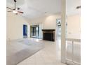Spacious living room features tile flooring, ceiling fan, fireplace, and lots of natural light at 3066 Landmark Blvd # 1305, Palm Harbor, FL 34684